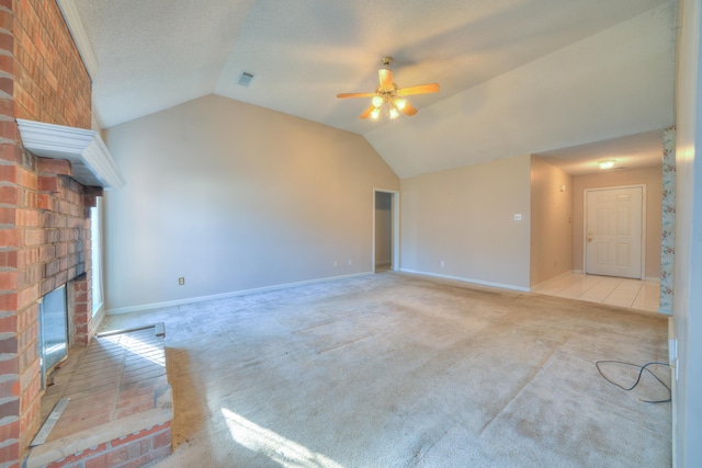 unfurnished living room with visible vents, a brick fireplace, ceiling fan, lofted ceiling, and carpet flooring