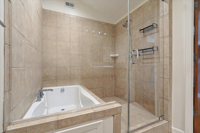 bathroom with a garden tub, visible vents, and a stall shower