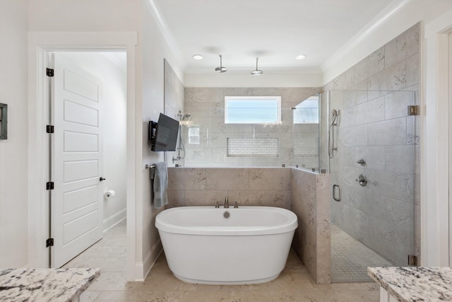 full bathroom with a shower stall, crown molding, a soaking tub, marble finish floor, and tile walls