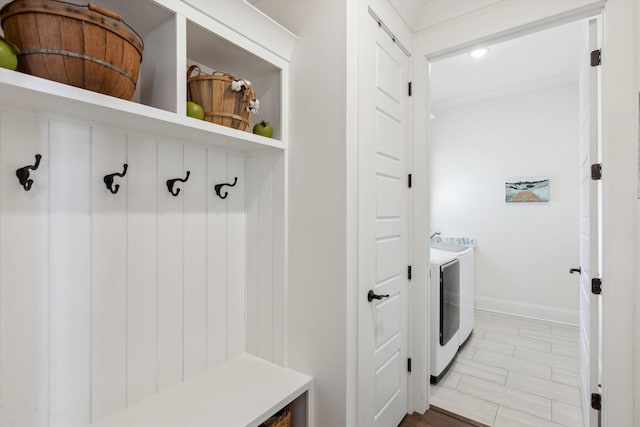 mudroom featuring washing machine and dryer and baseboards