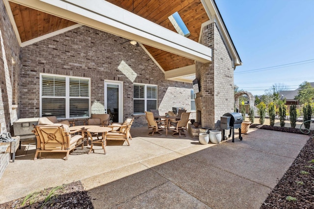 view of patio with outdoor dining area and a grill