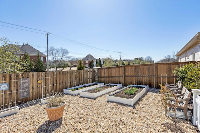 view of yard with a vegetable garden and fence