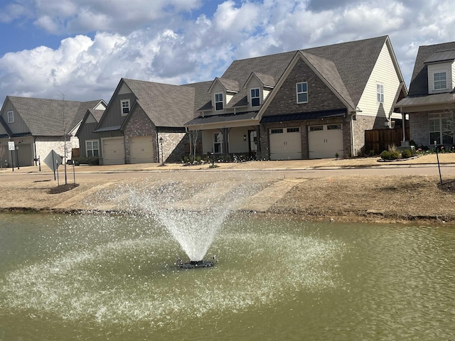 view of front of home with a garage, a residential view, and brick siding