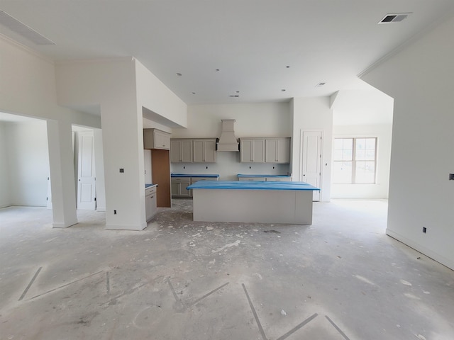9622 Grays Hollow Dr S, Cordova, TN 38018 - kitchen with gray cabinets, custom range hood, a high ceiling, and a center island