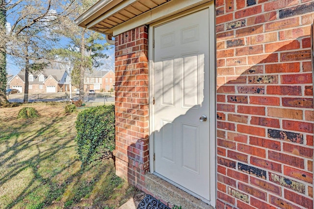 doorway to property with brick siding