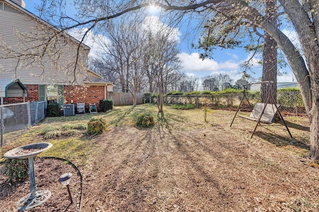 view of yard featuring a fenced backyard and central AC