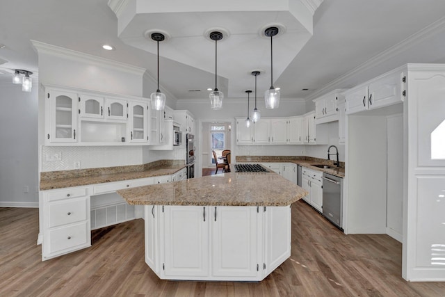 kitchen with appliances with stainless steel finishes, white cabinetry, and ornamental molding