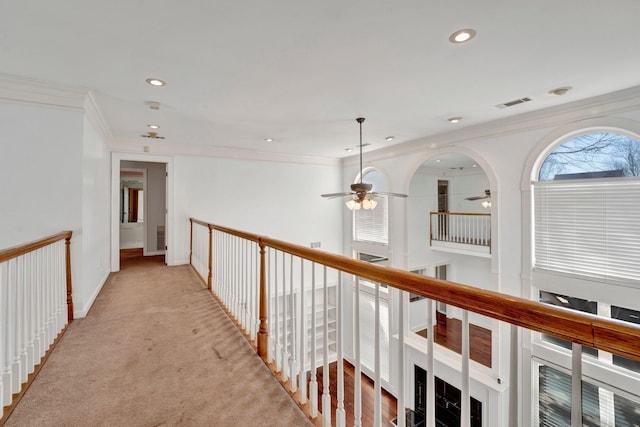 hall with recessed lighting, visible vents, light carpet, and crown molding