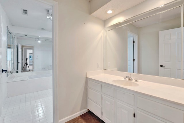 bathroom featuring recessed lighting, visible vents, baseboards, and vanity