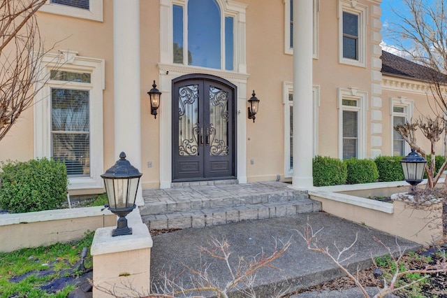 doorway to property featuring stucco siding