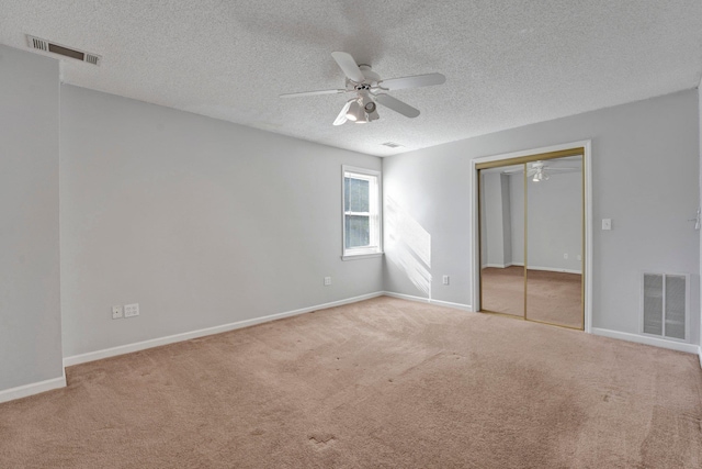 unfurnished bedroom featuring a closet, visible vents, baseboards, and carpet floors