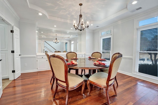 dining room featuring visible vents, baseboards, dark wood finished floors, a notable chandelier, and a raised ceiling