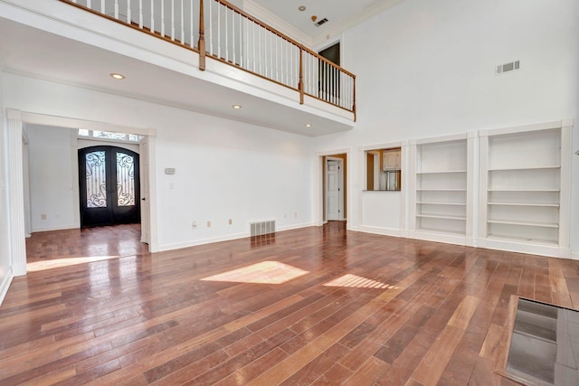 unfurnished living room featuring visible vents, french doors, baseboards, and hardwood / wood-style flooring