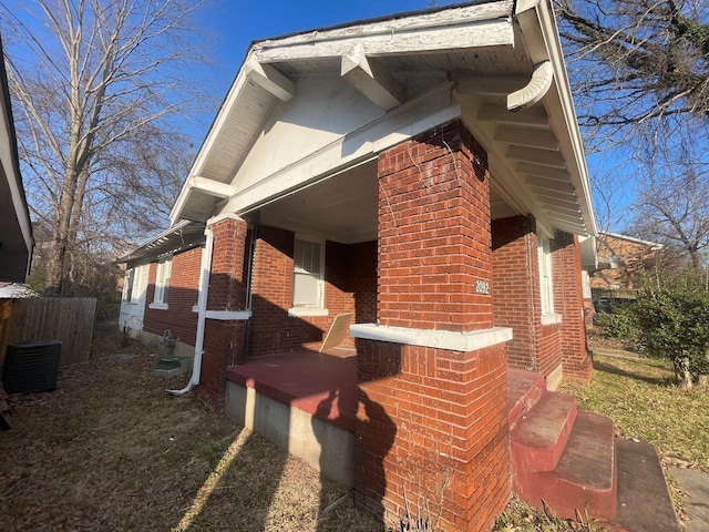 exterior space featuring brick siding and a porch