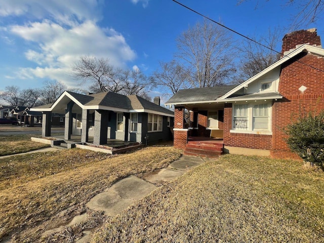 view of property exterior with brick siding and covered porch