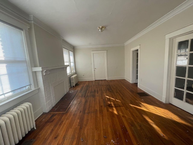 interior space with a brick fireplace, radiator heating unit, dark wood-style flooring, and ornamental molding