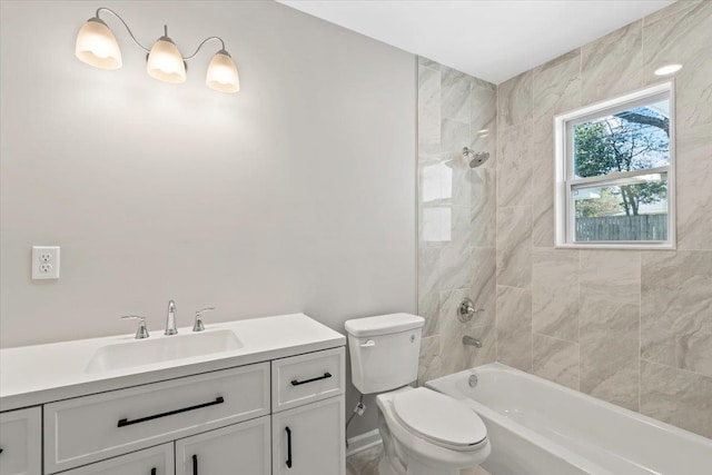 bathroom featuring vanity, shower / tub combination, and toilet