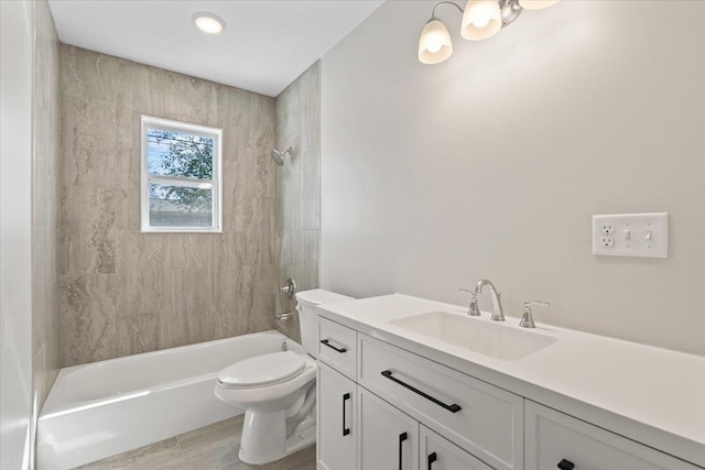 bathroom featuring vanity, toilet, bathing tub / shower combination, and wood finished floors