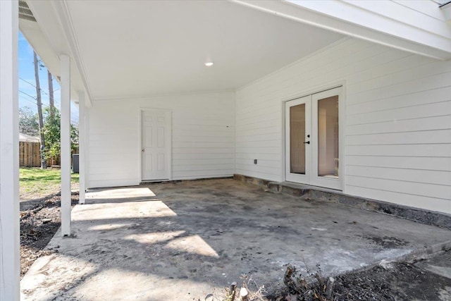 view of patio / terrace featuring a carport, french doors, and fence