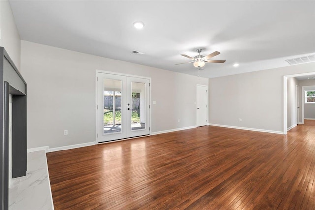 unfurnished living room featuring french doors, visible vents, wood-type flooring, and baseboards