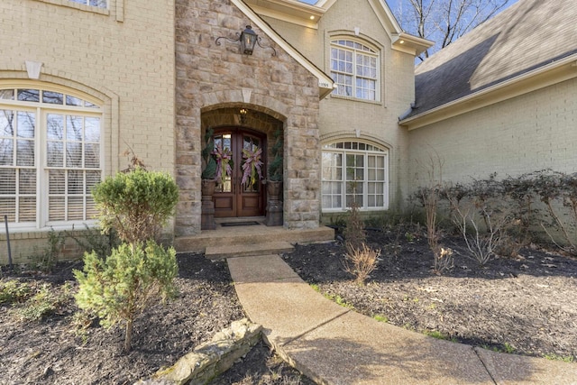 entrance to property with stone siding and brick siding