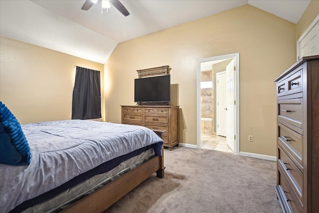 bedroom with connected bathroom, baseboards, light colored carpet, ceiling fan, and vaulted ceiling