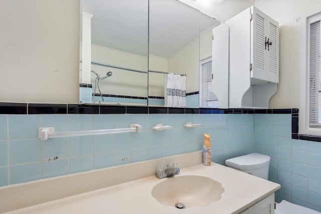 full bathroom featuring tile walls, toilet, and vanity