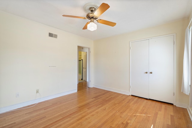 unfurnished bedroom with visible vents, baseboards, ceiling fan, light wood-style flooring, and a closet