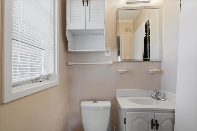 bathroom featuring visible vents, toilet, and vanity