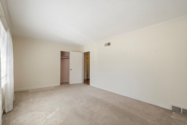 unfurnished bedroom with crown molding, baseboards, and visible vents