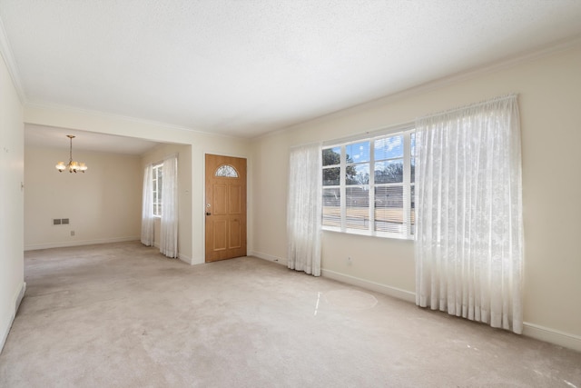 interior space featuring crown molding, baseboards, a chandelier, carpet floors, and a textured ceiling