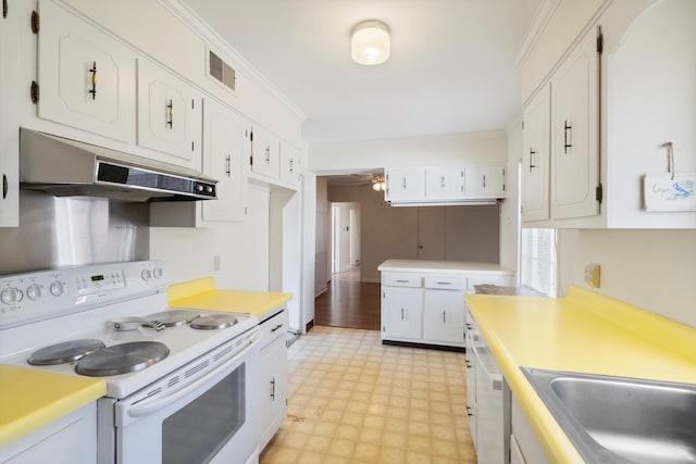 kitchen featuring visible vents, under cabinet range hood, white appliances, crown molding, and light floors