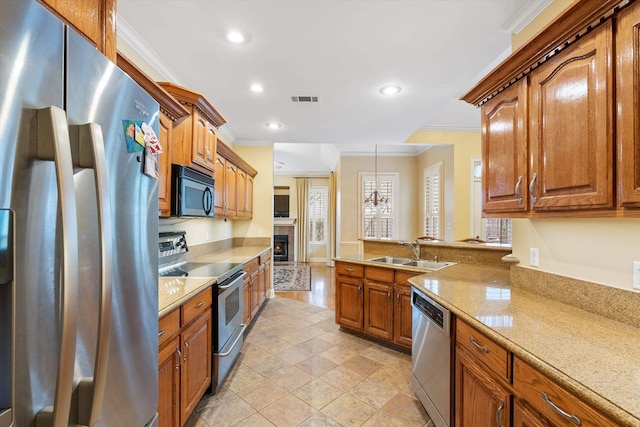 kitchen featuring visible vents, appliances with stainless steel finishes, crown molding, and a sink