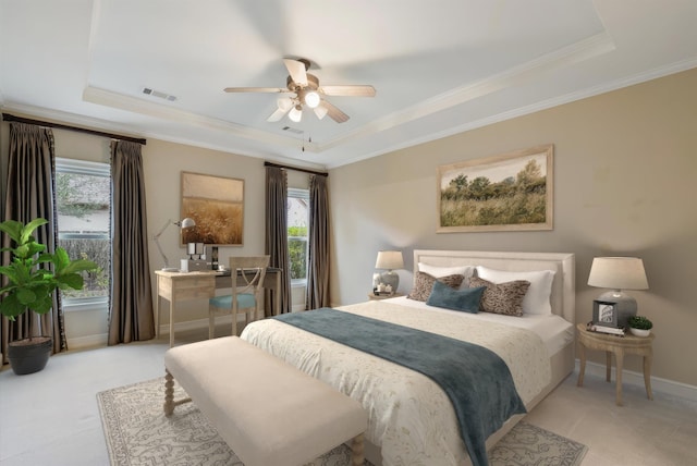 bedroom featuring visible vents, multiple windows, and a tray ceiling