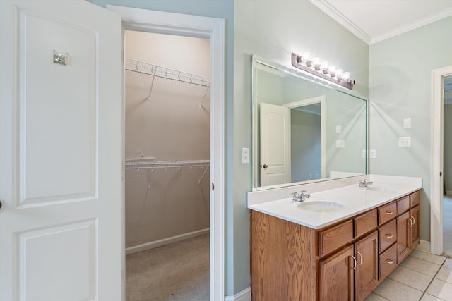 bathroom featuring double vanity, tile patterned flooring, ornamental molding, and a sink