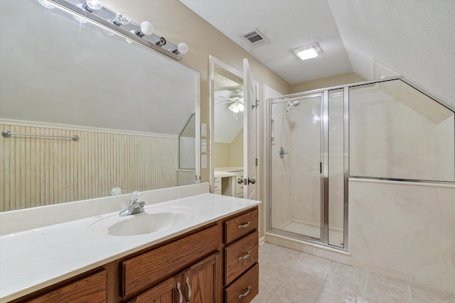 full bathroom with tile patterned floors, visible vents, a stall shower, lofted ceiling, and vanity