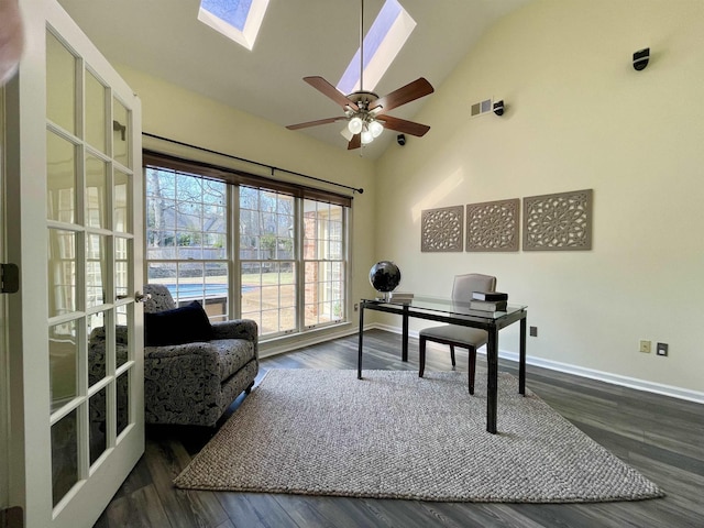 office featuring baseboards, high vaulted ceiling, a skylight, and dark wood-style flooring