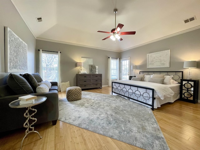 bedroom featuring visible vents, multiple windows, and wood finished floors