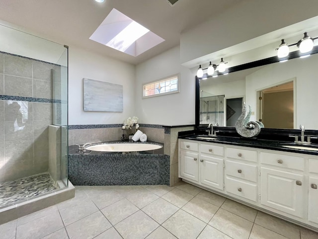 full bathroom with a shower stall, a bath, tile patterned floors, and a sink