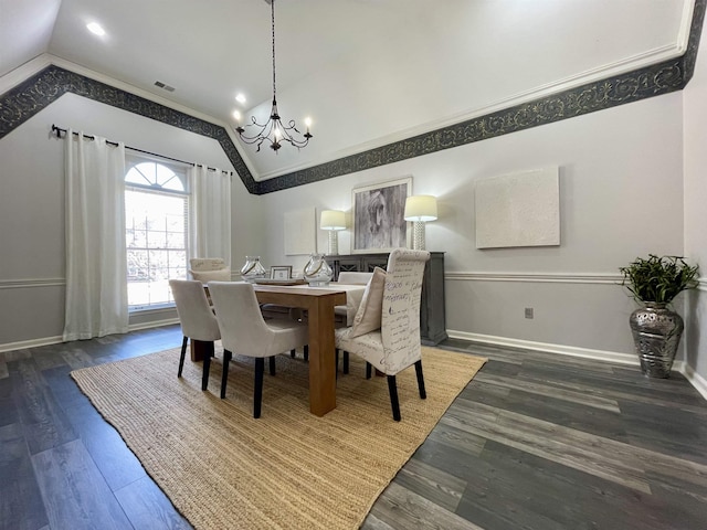 dining room featuring visible vents, baseboards, lofted ceiling, an inviting chandelier, and wood finished floors