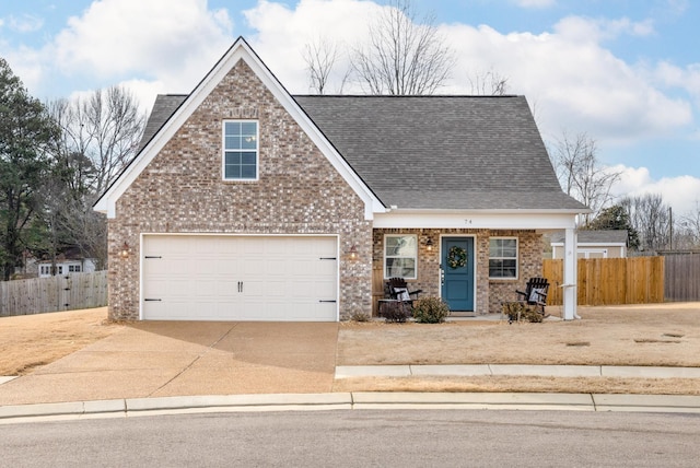 view of front facade featuring concrete driveway, fence, brick siding, and roof with shingles