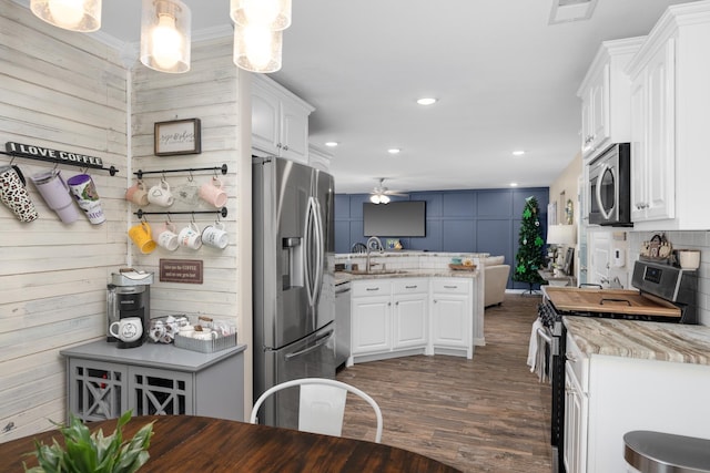 kitchen with a sink, stainless steel appliances, visible vents, and white cabinets