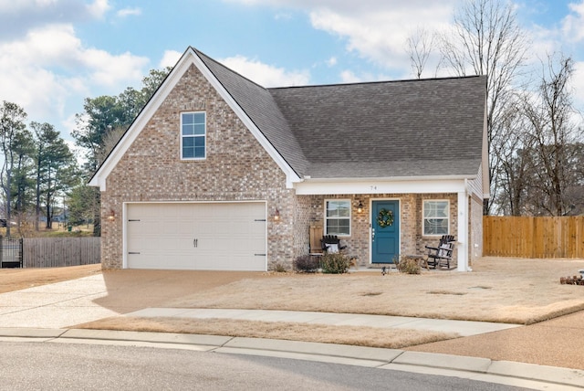 view of front of house with concrete driveway, fence, brick siding, and roof with shingles