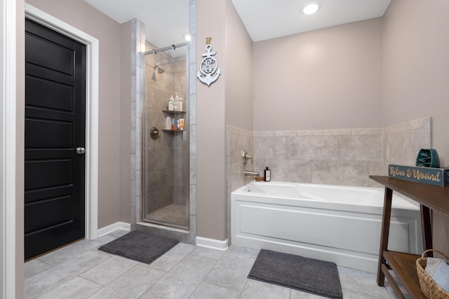 full bath with a bath, tile patterned flooring, a stall shower, and baseboards