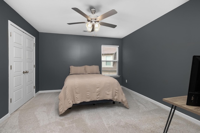 bedroom featuring baseboards, carpet floors, and a ceiling fan