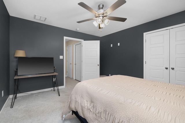 bedroom with visible vents, a closet, carpet flooring, baseboards, and ceiling fan