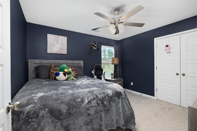 carpeted bedroom featuring visible vents, baseboards, a closet, and a ceiling fan