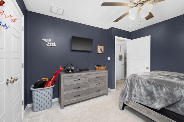 bedroom featuring light carpet, visible vents, ceiling fan, and baseboards