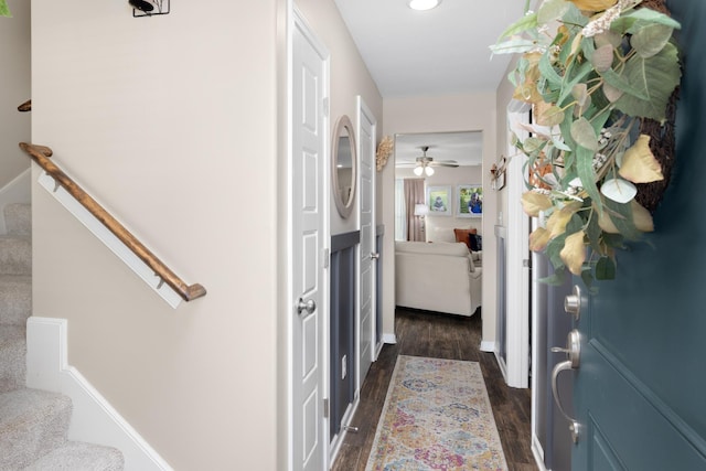 hall featuring dark wood finished floors and stairs