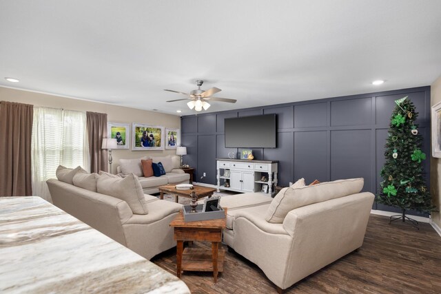 living area featuring a decorative wall, recessed lighting, a ceiling fan, and dark wood-style flooring